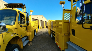 In Between Two Concord Road Equipment Yellow Work Zone Trucks