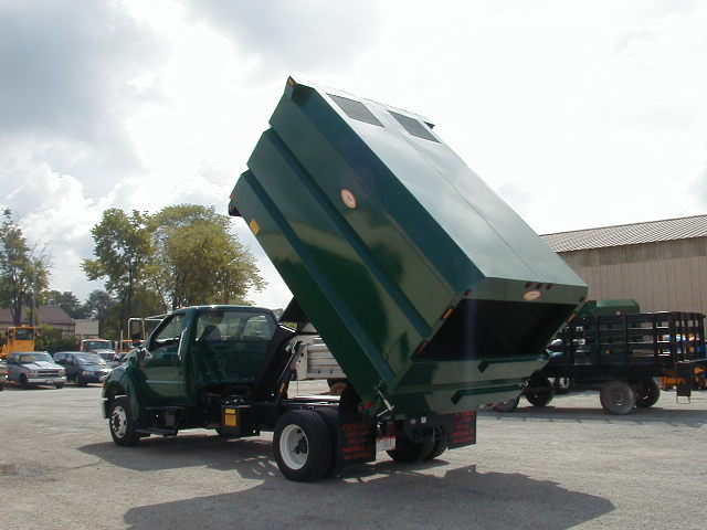 Concord Road Equipment Green Truck With Leaf Container Raised Left Rear